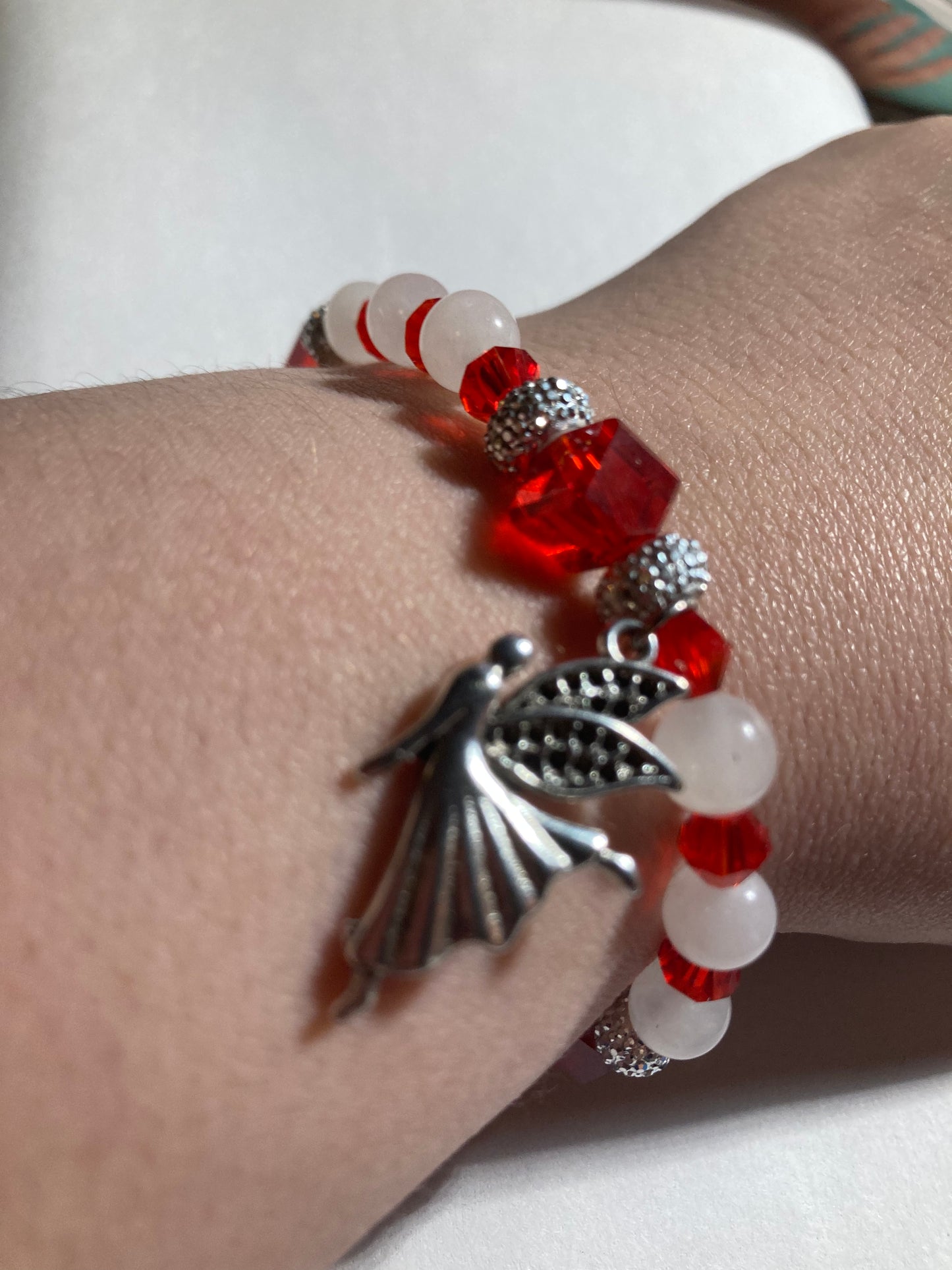 White Quartz, Crystal Siam corner cut cubes, and Chakra gemstones with a dainty Tibetan silver fairy dangling.