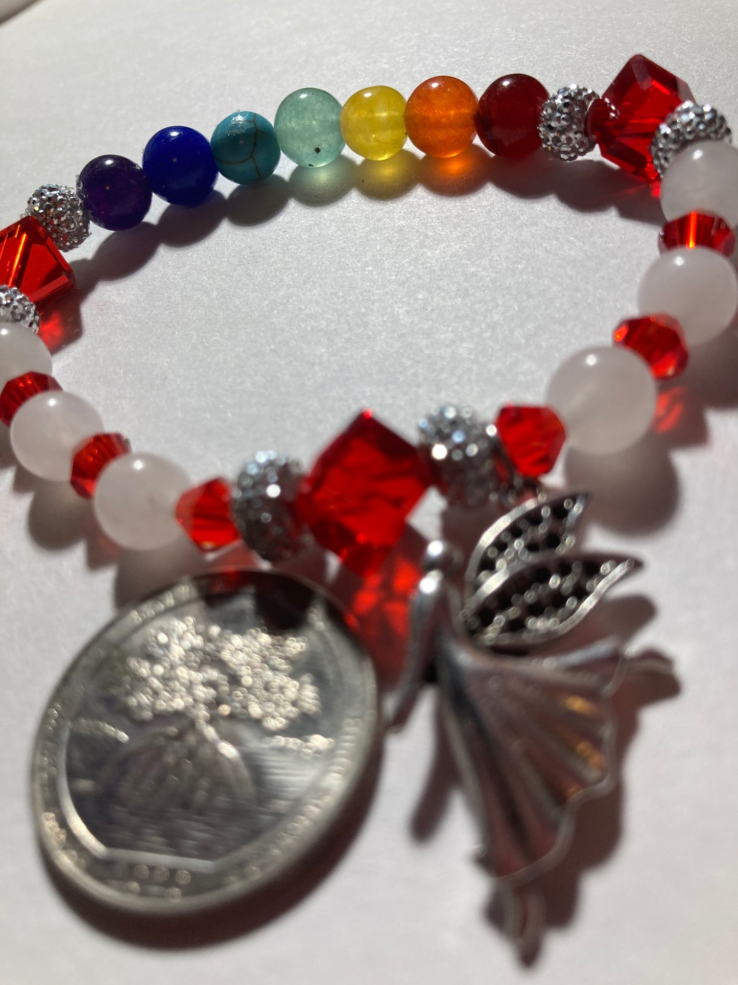 White Quartz, Crystal Siam corner cut cubes, and Chakra gemstones with a dainty Tibetan silver fairy dangling.