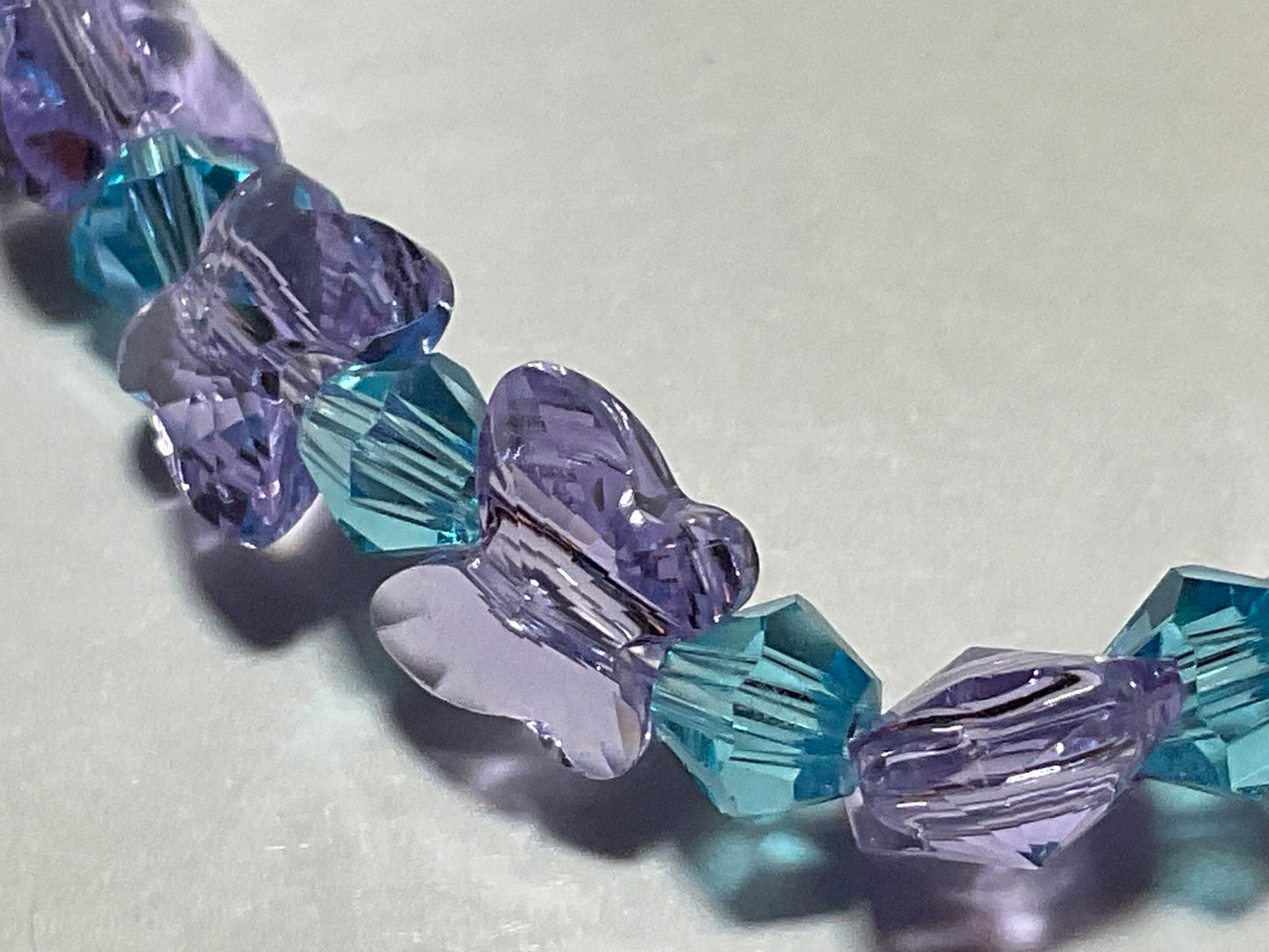 Artisan made Violet Butterfly & Aquamarine crystal Stretch bracelet. Handmade in Michigan!. Made using Swarovski Violet Butterfly Crystals.