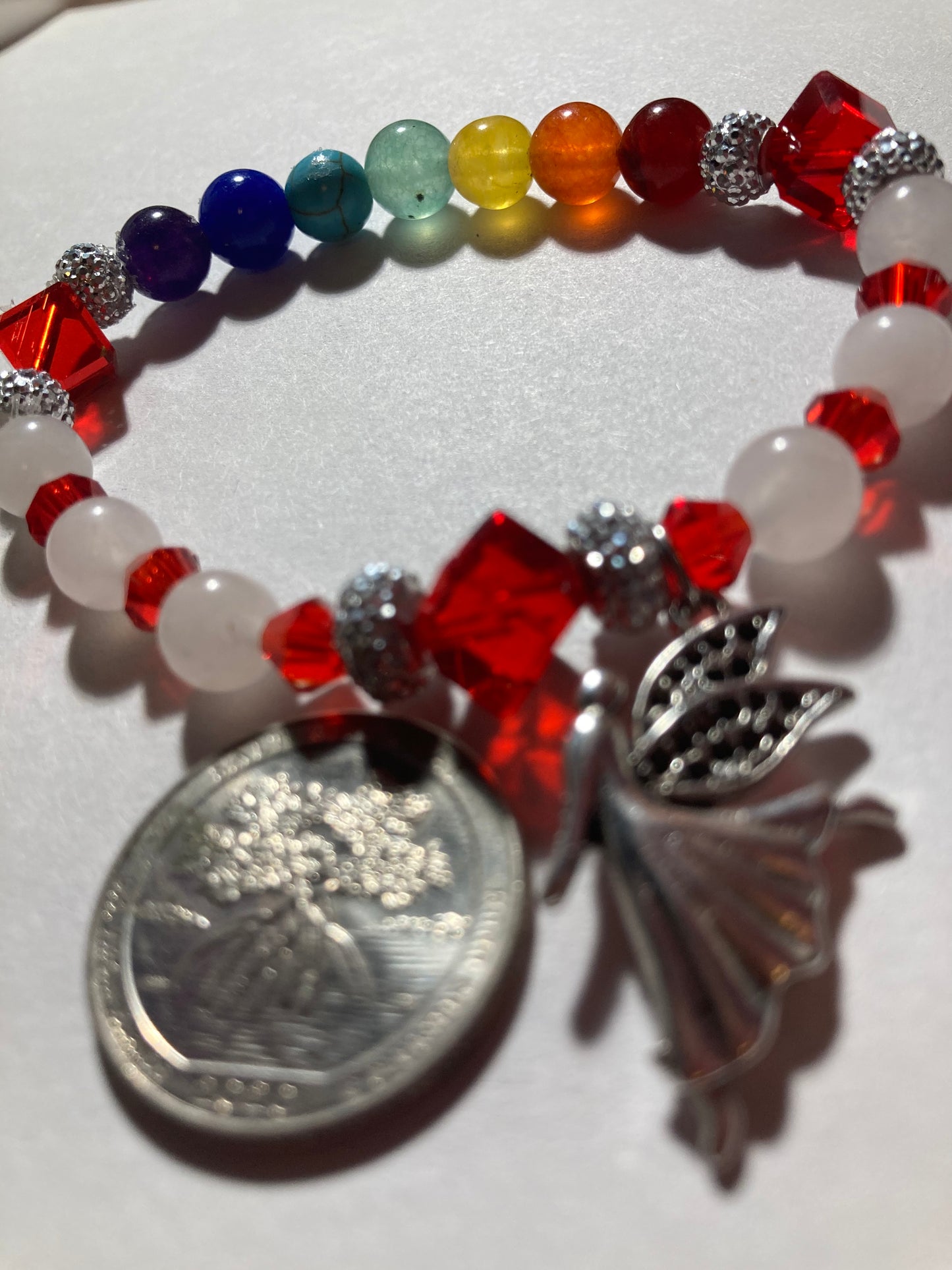 White Quartz, Crystal Siam corner cut cubes, and Chakra gemstones with a dainty Tibetan silver fairy dangling.