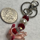 Adorable Axolotl w/Santa hat featuring stainless steel wire adorned with Sparkling Clear, & Red Crystals & Glass Pearls, Beautiful & Fun keychain/backpack/purse/tote charm