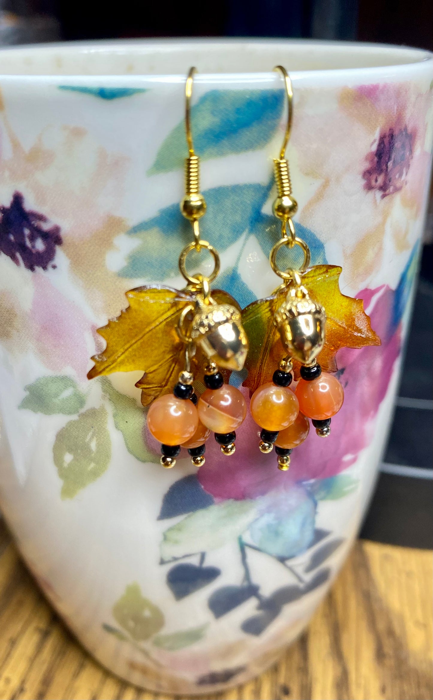 Bring on fall fun! Swaying Golden Acorns, Carnelian Gemstones and And Hand Painted Maple Leaves! Earrings feature Gold Plated Earring hooks, beads, and Acorns.