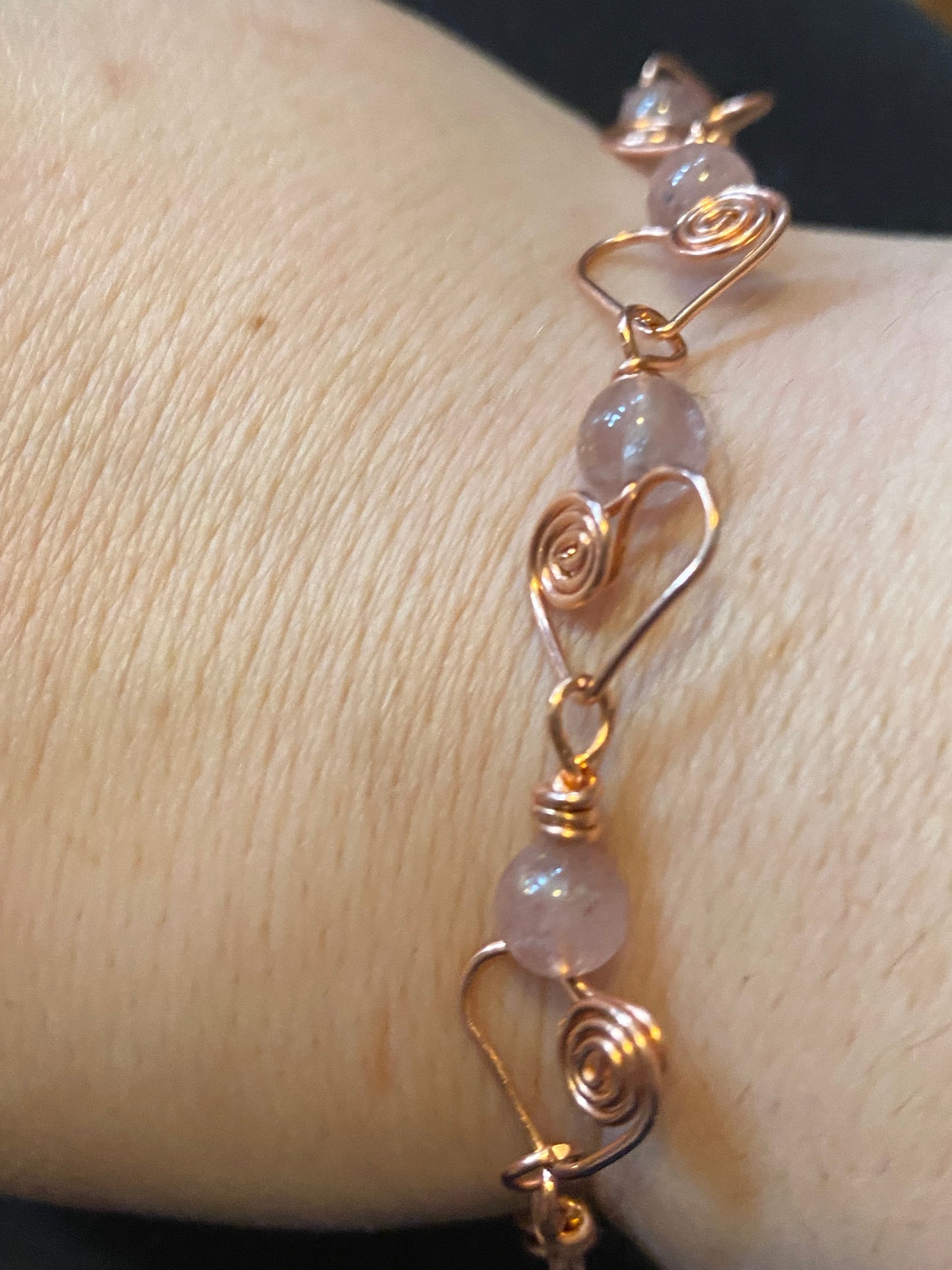 Adorable and Enchanting! Bracelet! Artisan made with Bare Copper, Hearts with swirls are adorned with Pink Strawberry Quartz Gemstones to complete this look!