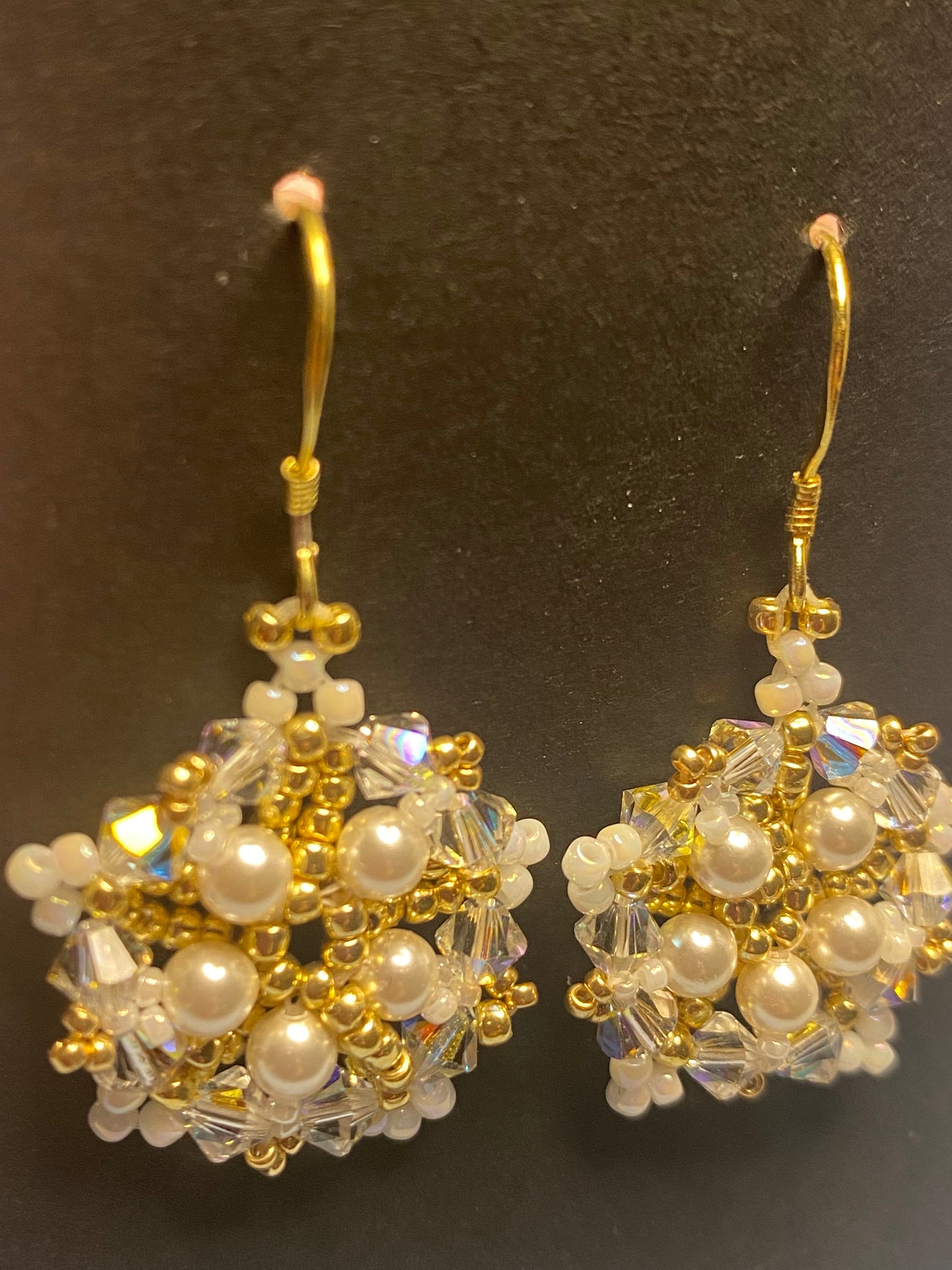 White Snowflake earrings feature shimmering Swarovski pearls and crystals. Elevate any outfit with the delicate touch of gold and sparkle.