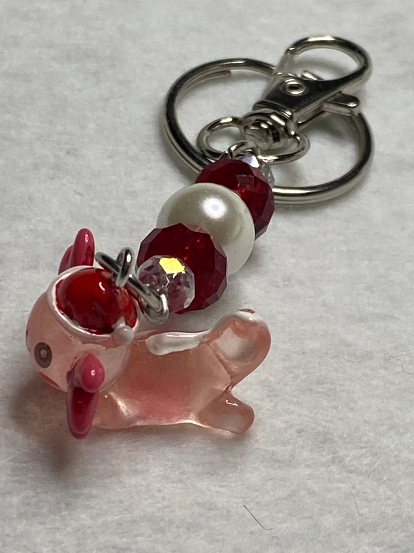 Adorable Axolotl w/Santa hat featuring stainless steel wire adorned with Sparkling Clear, & Red Crystals & Glass Pearls, Beautiful & Fun keychain/backpack/purse/tote charm