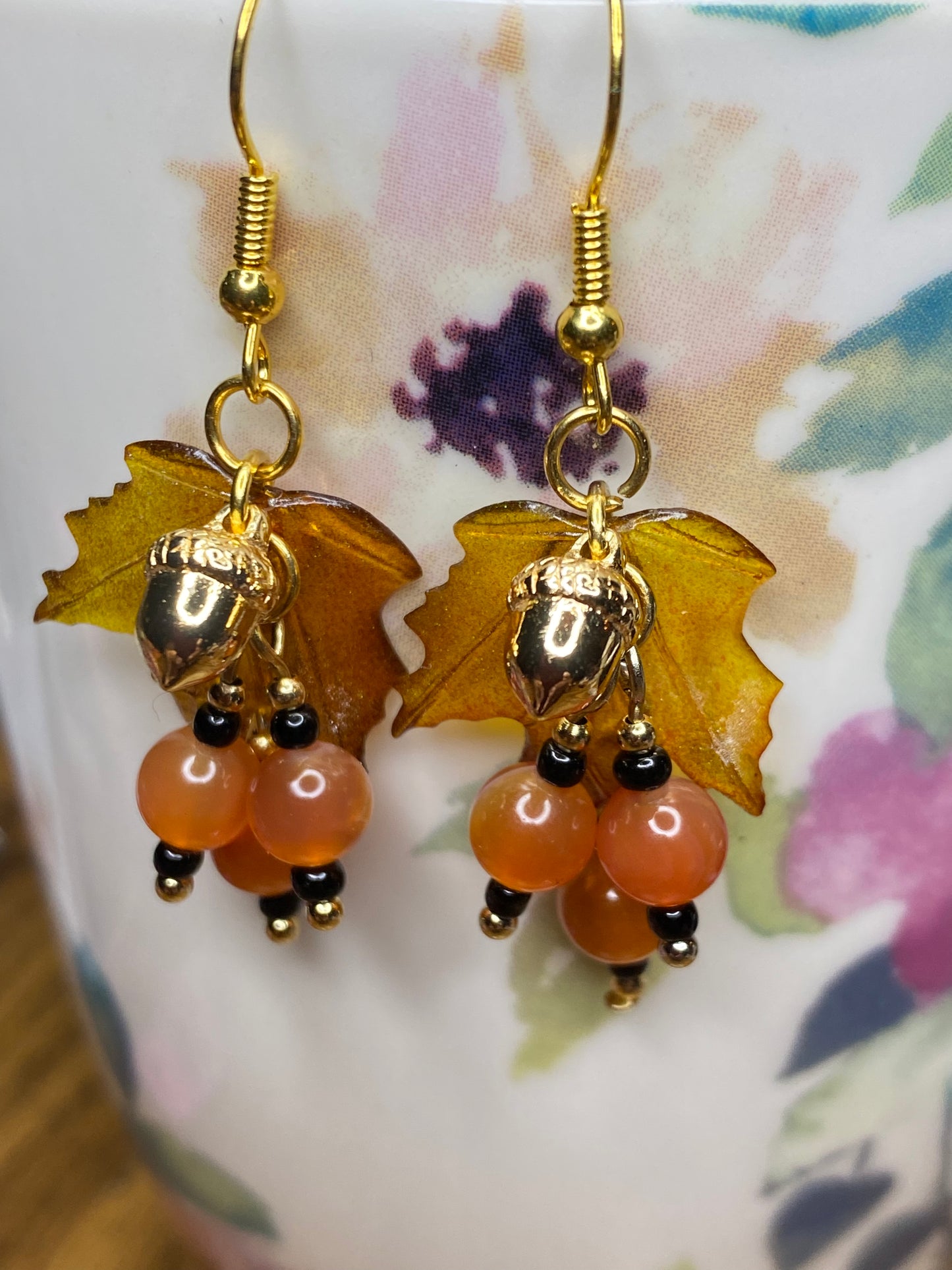 Bring on fall fun! Swaying Golden Acorns, Carnelian Gemstones and And Hand Painted Maple Leaves! Earrings feature Gold Plated Earring hooks, beads, and Acorns.