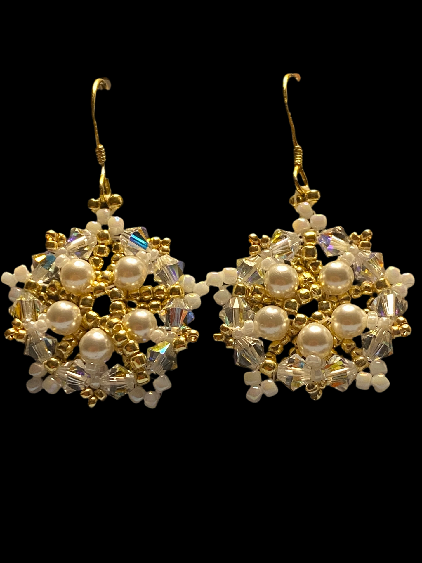 White Snowflake earrings feature shimmering Swarovski pearls and crystals. Elevate any outfit with the delicate touch of gold and sparkle.