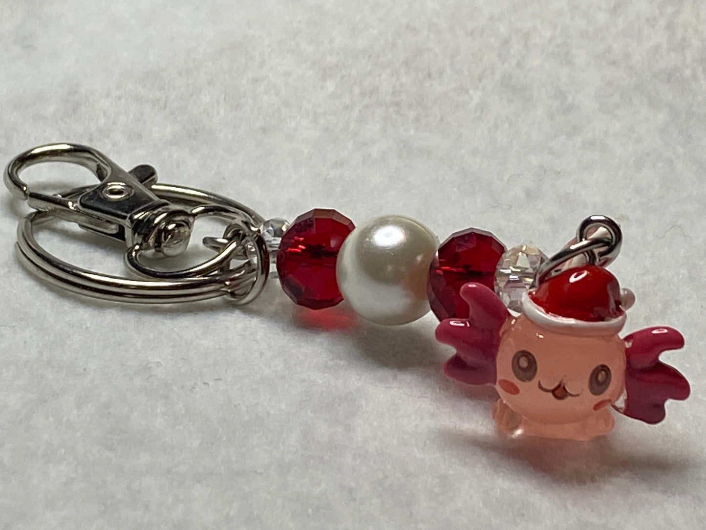 Adorable Axolotl w/Santa hat featuring stainless steel wire adorned with Sparkling Clear, & Red Crystals & Glass Pearls, Beautiful & Fun keychain/backpack/purse/tote charm