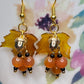 Bring on fall fun! Swaying Golden Acorns, Carnelian Gemstones and And Hand Painted Maple Leaves! Earrings feature Gold Plated Earring hooks, beads, and Acorns.