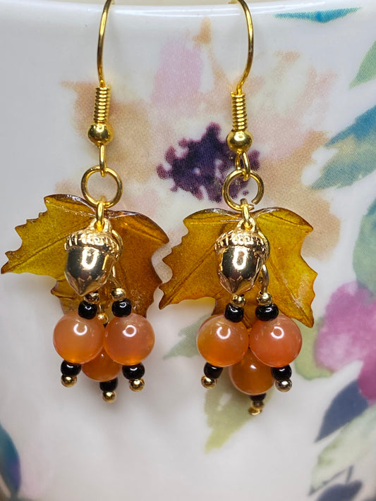 Bring on fall fun! Swaying Golden Acorns, Carnelian Gemstones and And Hand Painted Maple Leaves! Earrings feature Gold Plated Earring hooks, beads, and Acorns.