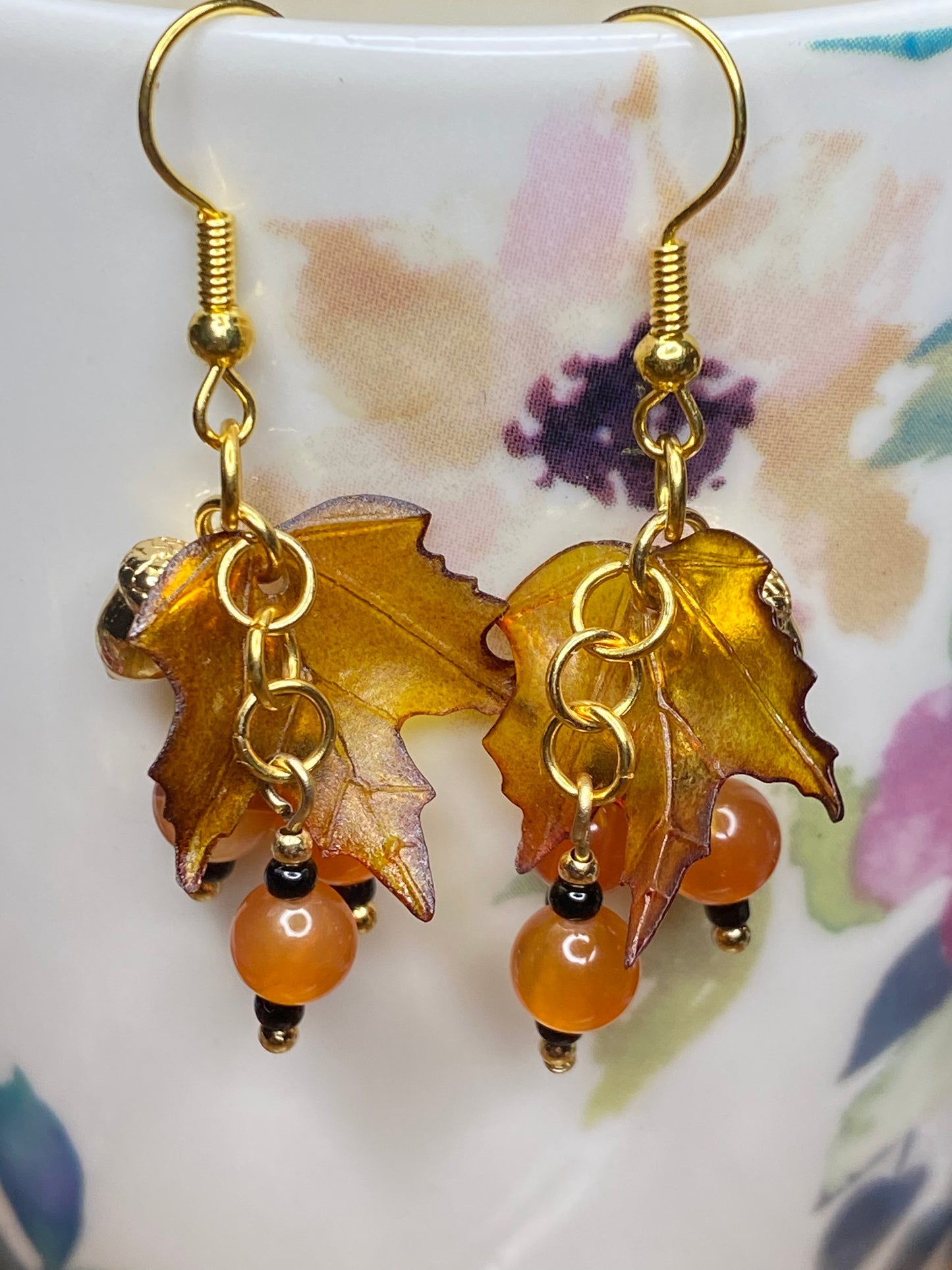 Bring on fall fun! Swaying Golden Acorns, Carnelian Gemstones and And Hand Painted Maple Leaves! Earrings feature Gold Plated Earring hooks, beads, and Acorns.