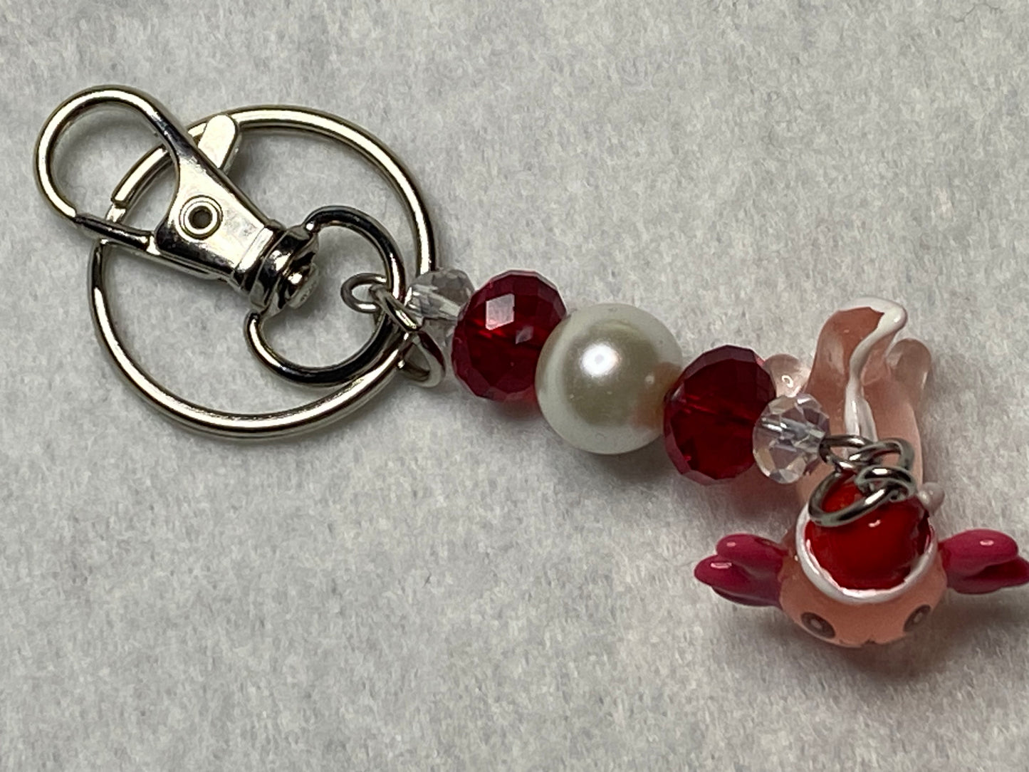 Adorable Axolotl w/Santa hat featuring stainless steel wire adorned with Sparkling Clear, & Red Crystals & Glass Pearls, Beautiful & Fun keychain/backpack/purse/tote charm