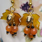 Bring on fall fun! Swaying Golden Acorns, Carnelian Gemstones and And Hand Painted Maple Leaves! Earrings feature Gold Plated Earring hooks, beads, and Acorns.