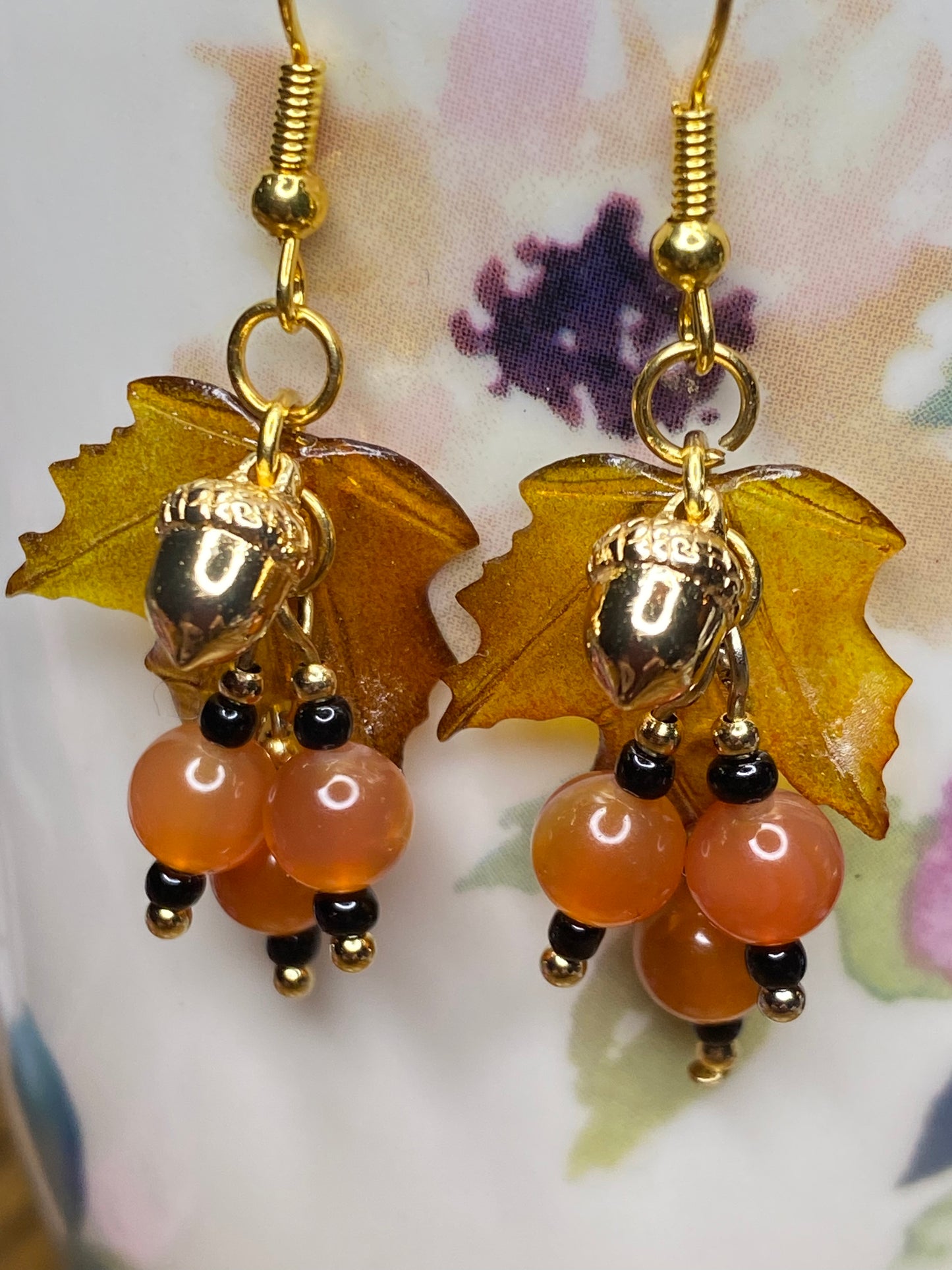 Bring on fall fun! Swaying Golden Acorns, Carnelian Gemstones and And Hand Painted Maple Leaves! Earrings feature Gold Plated Earring hooks, beads, and Acorns.