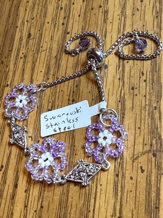 Austrian Swarovski Crystal and seedbeaded lavender embellished with Tanzanite colored Swarovski Crystals on the ends adjustable stainless Steel