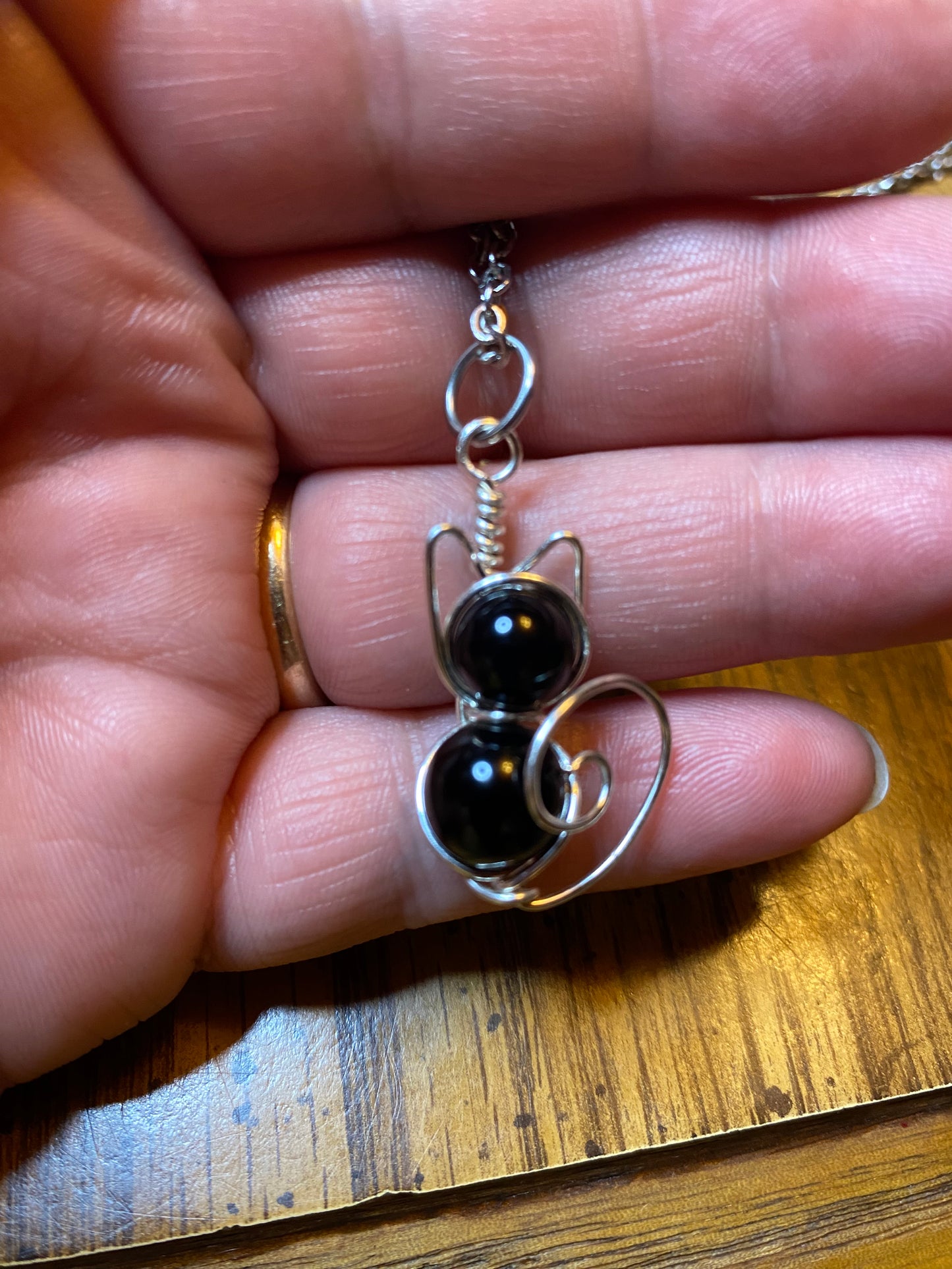 Artisan Purrfect Cat Pendant. A Cat pendant featuring Black Onyx and Silver plated wire while offering long term durability with a Stainless Steel chain.