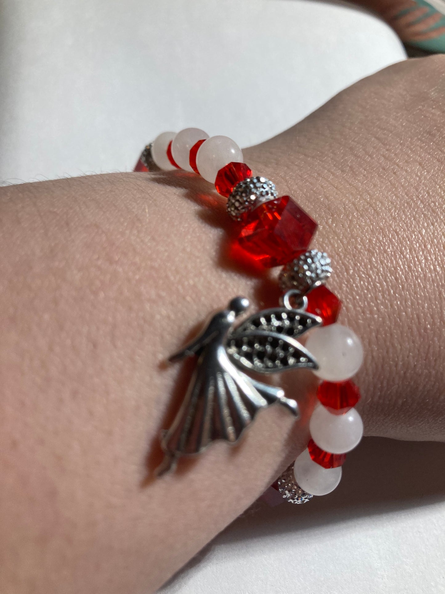 White Quartz, Crystal Siam  corner cut cubes, and Chakra gemstones with a dainty Tibetan silver fairy dangling.