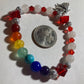 White Quartz, Crystal Siam  corner cut cubes, and Chakra gemstones with a dainty Tibetan silver fairy dangling.