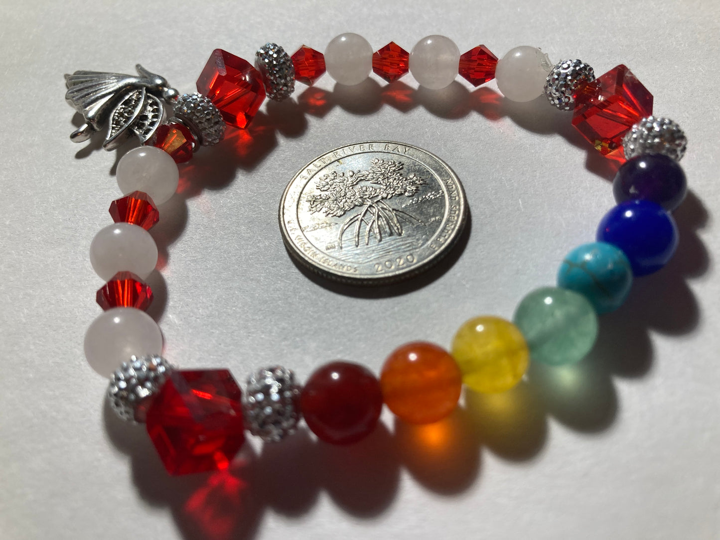 White Quartz, Crystal Siam  corner cut cubes, and Chakra gemstones with a dainty Tibetan silver fairy dangling.