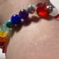 White Quartz, Crystal Siam  corner cut cubes, and Chakra gemstones with a dainty Tibetan silver fairy dangling.