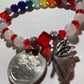 White Quartz, Crystal Siam  corner cut cubes, and Chakra gemstones with a dainty Tibetan silver fairy dangling.